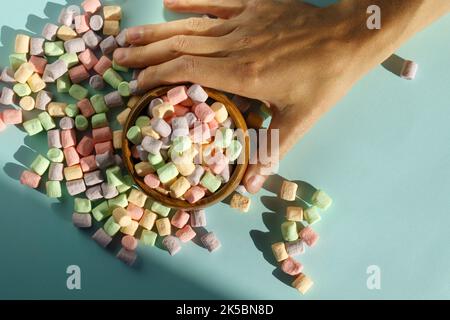 The background or texture of a colorful mini marshmallow. The concept of winter food. Top view Stock Photo