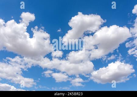 White cumulus clouds against blue sky, West Mersea, Essex, England, United Kingdom Stock Photo
