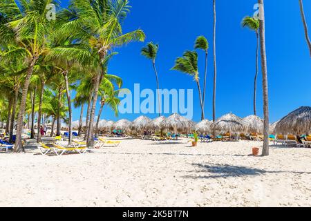 Beautiful white sandy beach of a luxury resort in Punta Cana, Dominican Republic. Coconut Palm trees on white sandy beach. View of nice tropical beach Stock Photo