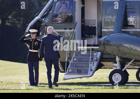 President Joe Biden returns a salute as he walks to board Air Force One ...