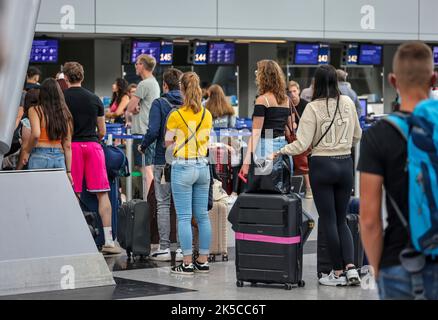 Düsseldorf airport, vacationers waiting at check-in counter, North Rhine-Westphalia, Germany Stock Photo