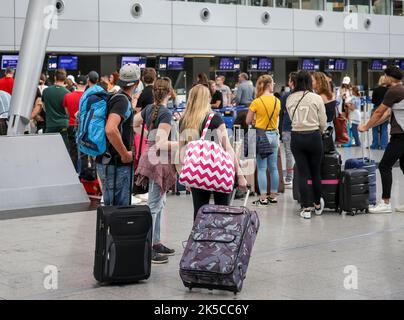 Düsseldorf airport, vacationers waiting at check-in counter, North Rhine-Westphalia, Germany Stock Photo