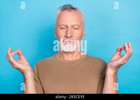 Close up photo of attractive old man dressed pastel stylish clothes eyes closed enjoy free time hobby isolated on blue color background Stock Photo