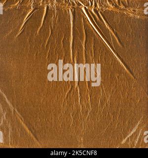 Wrinkled gold colored paper meant as background Stock Photo