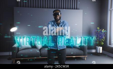 A young black man uses virtual reality glasses and immerses himself in the virtual world. New technologies. Entertainment of the future Stock Photo