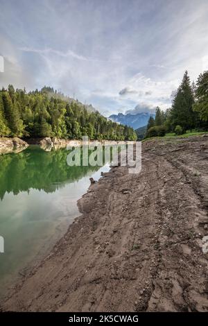 Italy, Veneto, province of Belluno, Domegge di Cadore. Centro Cadore lake, extremely low water level, the shores of the lake emerge between mud and dirt Stock Photo