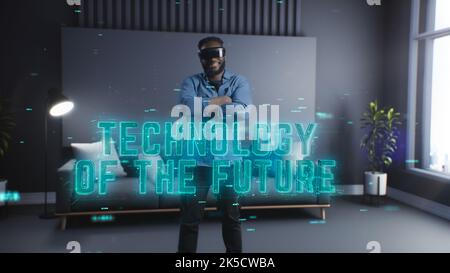 Young man uses virtual or augmented reality glasse, female VR headset user at digital interactive performance. Pop-up text hologram Stock Photo