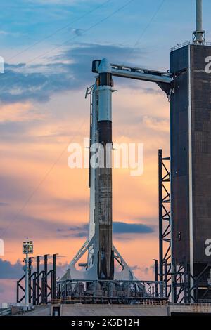 A SpaceX Falcon 9 rocket, with the company’s Cargo Dragon spacecraft atop, is raised to a vertical position at NASA Kennedy Space Center’s Launch Complex 39A on July 12, 2022, in preparation for the 25th commercial resupply services launch to the International Space Station. The mission will deliver new science investigations, supplies, and equipment to the crew aboard the orbiting laboratory. Liftoff is scheduled for 8:44 p.m. EDT on Thursday, July 14, from Kennedy’s Launch Complex 39A. Stock Photo