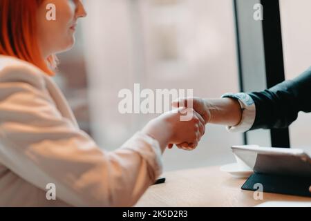 Business women shake hands while arranging a business Stock Photo