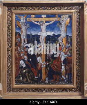 The Crucifixion, late 15th-early 16th century. Centre panel of a triptych. Christ between the thieves whose souls are taken by a devil and an angel; group of holy women to the right of Christ, soldiers on his left; Mary Magdalene, on her knees, hugs the foot of the cross. (La Crucifixion ; sc&#xe8;nes de la vie et de la Passion du Christ). Stock Photo