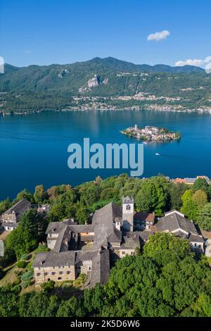 Aerial view of the Sacro Monte of Orta and the Isola di San Giulio on Lake Orta in the summer. Orta Lake, Province of Novara, Piedmont, Italy. Stock Photo