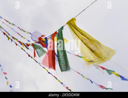 Buddhist prayer flags swaying in the wind against the sky. Kathmandu, Nepal Stock Photo