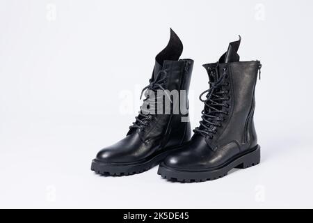 Black women's leather lace-up boots from the new collection on a white background from leather autumn-winter 2022. Boots close-up Stock Photo