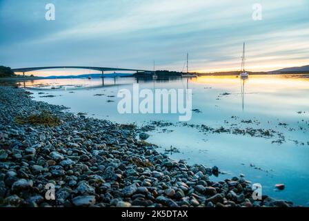 Opened in 1995,the road bridge connecting the Isle of Skye to the island of Eilean Bàn and the Scottish mainland.The sun setting close to midnight in Stock Photo