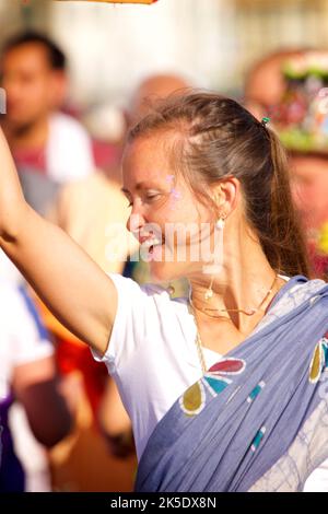 The annual Rathayatra Festival for Lord Krishna and his devotees promenades along Hove esplanade each year. Krishna in his form of Jagannatha is pulled along on a large wooden juggernaut. Devotee dancing. Stock Photo