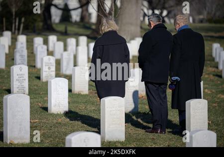 NASA Deputy Administrator Pam Melroy, left, NASA Associate Administrator Bob Cabana, and NASA Administrator Bill Nelson, right, stop at the gravesite of former astronaut and U.S. Senator John Glenn to pay their respects, Thursday, Jan. 27, 2022, at Arlington National Cemetery in Arlington, Va.  Nelson, Melroy, and Cabana had earlier laid wreaths in memory of those men and women who lost their lives in the quest for space exploration as part of NASA's Day of Remembrance. Stock Photo
