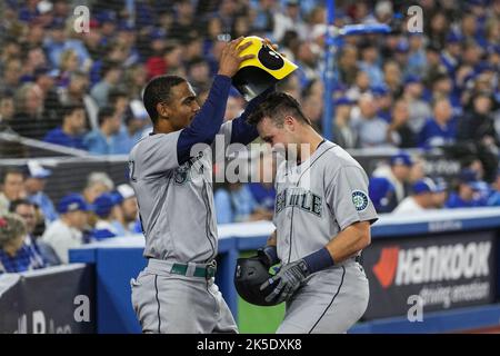 CLEVELAND, OH - SEPTEMBER 02: Seattle Mariners center fielder Julio  Rodriguez (44) puts the home run helmet on Seattle Mariners catcher Cal  Raleigh (29) after Raliegh hit his second home run of