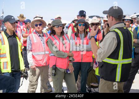 NASA astronaut and Crew Recovery Chief Shannon Walker, center, and other NASA and Boeing teams listen to Boeing Starliner Launch Conductor Louis Atchison as they prepare for the landing of Boeing’s CST-100 Starliner spacecraft at White Sands Missile Range’s Space Harbor, Wednesday, May 25, 2022, in New Mexico. Boeing’s Orbital Flight Test-2 (OFT-2) is Starliner’s second uncrewed flight test to the International Space Station as part of NASA's Commercial Crew Program. OFT-2 serves as an end-to-end test of the system's capabilities. Stock Photo