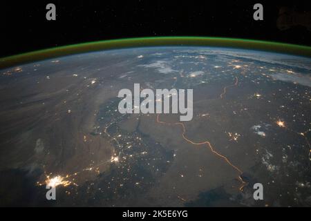 A crew member of Expedition 45 on the International Space Station captured this nighttime panorama in September 2015, looking north across Pakistan's Indus River valley. This photograph shows one of the few places on Earth where an international boundary can be seen at night. Security lights with a distinct orange tone light the winding border between Pakistan and India.  A unique version of an original NASA image. Credit: NASA Stock Photo
