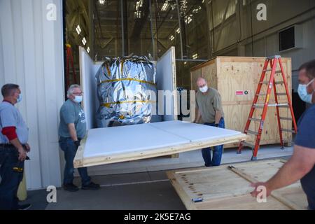 Teams working at Building 836 on Vandenberg Space Force Base in California remove NASA’s Low-Earth Orbit Flight Test of an Inflatable Decelerator (LOFTID) from its shipping container on Monday, Aug. 15, 2022. LOFTID is a rideshare launching with the National Oceanic and Atmospheric Administration’s (NOAA) Joint Polar Satellite System-2 (JPSS-2) satellite. The technology demonstration mission is slated to test new capabilities for landing payloads, including in a thinner atmosphere like that on Mars. Stock Photo