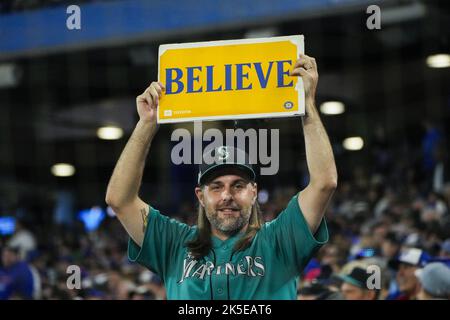 Seattle Mariners fans stand next to a Believe sign during a baseball game  against the Oakland Athletics, Wednesday, Sept. 29, 2021, in Seattle. Fans  and the team have adopted the one-word slogan