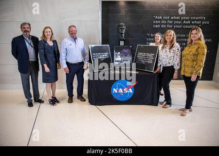 Kennedy Space Center Director Janet Petro, second from left, poses with Maverick Constructors LLC employees, from left, Carlos Rodriguez, president, Ralph Kennedy, East Coast division manager, Liz McGrath, Sheri LaShier, and Stephanie Liquori inside Kennedy’s Central Campus Headquarters Building on May 3, 2022. Maverick, the construction company that completed the demolition of Kennedy’s former headquarters, presented Petro with two preserved sections of the building. The presentation of the 15-pound wall tiles is in honor of the many civil servants and contractors who dedicated their lives to Stock Photo