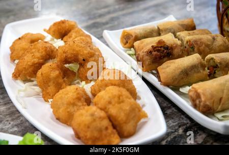 Assorted Thai Fish Cakes and Spring Rolls. Stock Photo