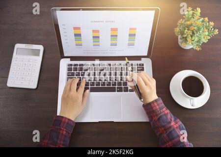 Young Businessman Analyzing Graph On Computer At Workplace Stock Photo