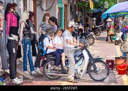 Vivian Filipic, 4, poses for grandparents Keith Mickelson and Alyce Wong  Mickelson to take her picture with a gift-wrapped toy motorcycle brought as  a present a day before her fifth birthday by