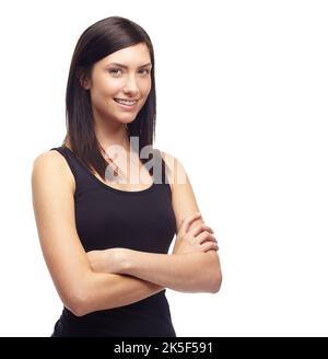 Simply stunning. A beautiful young woman crossing her arms while isolated on a white background. Stock Photo