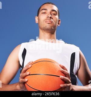 Do you want to challenge me. A young sportsman clutching a basketball. Stock Photo