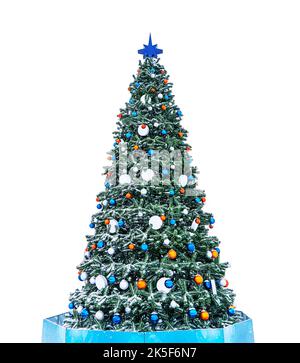 Beautiful Christmas tree decorated with red balls. Snowy Christmas tree with blue star isolated on white background. Stock Photo