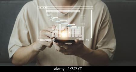 Analyst working with computer in Startup business concept. Businessman touching tablet with hologram of Data management system statistics and analytic Stock Photo