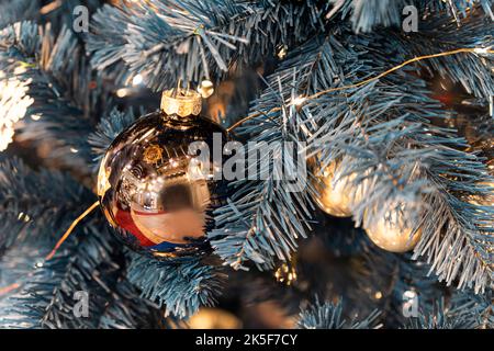 Festive Christmas tree toys and the lights . golden balls on the branch of the Christmas tree. christmas decorations. Stock Photo