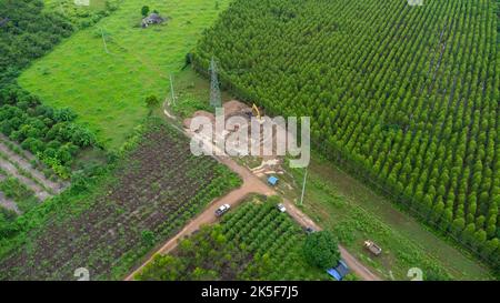 Aerial view of excavators are working on the foundations of high-voltage pylons and the legs of high-voltage poles. Top view of construction of power Stock Photo