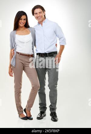 Perfect partners. Portrait of a multi-ethnic couple standing isolated on a white background. Stock Photo