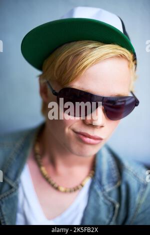 Street smart. Attractive young blond guy wearing street-style clothing and a smirk. Stock Photo