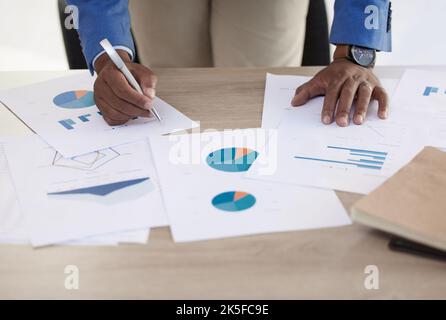 Businessman, hands and data on paper, analytics and graph for accounting in finance business on desk. Black man, working and writing on document for Stock Photo