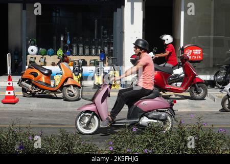 Fethiye daily life, people rides scooter at Ataturk caddesi. Stock Photo