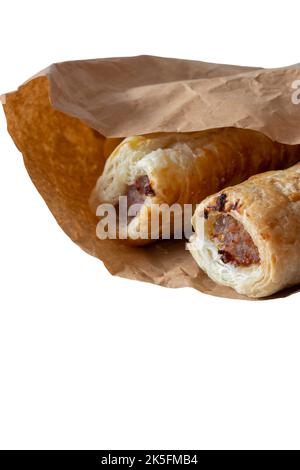 Sausage rolls in a brown paper bag, environmentally friendly biodegradable packaging. Isolated on a white background Stock Photo