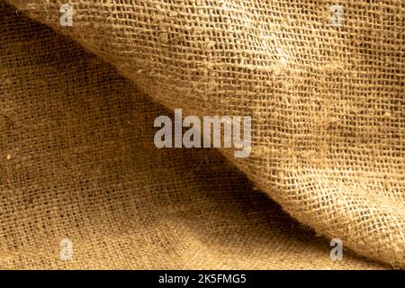 Homespun fabric with a rough texture. Close-up, selective focus. Stock Photo