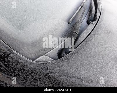 Snow covered car window with wipers, macro, close up Stock Photo