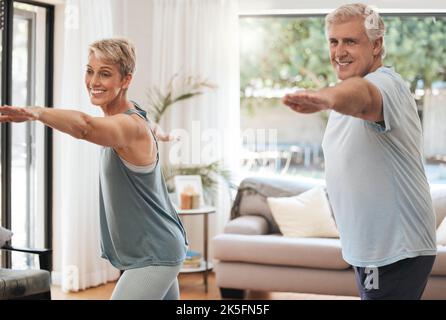 Yoga, fitness and senior couple doing home workout, training and wellness exercise in the living room together. Smile, old man and happy woman Stock Photo