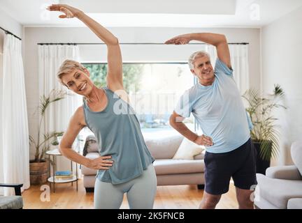 Stretching, yoga and fitness with a senior couple doing an exercise, workout or training at home. Health and wellness, lifestyle and active with a fit Stock Photo