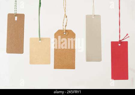 Blank red price tag label with a hanging string tied to the paper as a  commercial symbol of marketing and advertising a sale or Stock Photo - Alamy