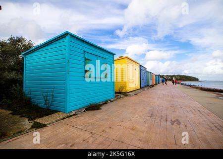 Beach huts and promenade at St Helens Duver, Isle of Wight, England UK Stock Photo