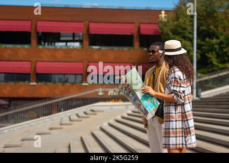 Two guys are walking in the city and having a lot of conversation Stock Photo