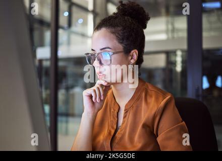 Night work, planning and business woman reading an email about web design in a dark office. Software worker programming, coding and working in Stock Photo