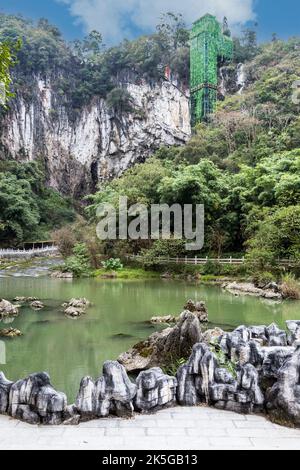 China, Guizhou, Dragon Palace Scenic Area.  Camouflaged Elevator leads to the Lake leading to the Cave Entrance. Stock Photo