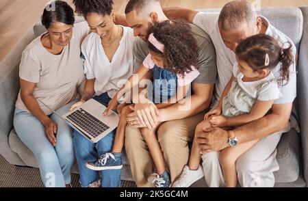 Top view, laptop and family watch cartoon movies or streaming online in the living room on a sofa. Diverse senior people, with parents and Stock Photo